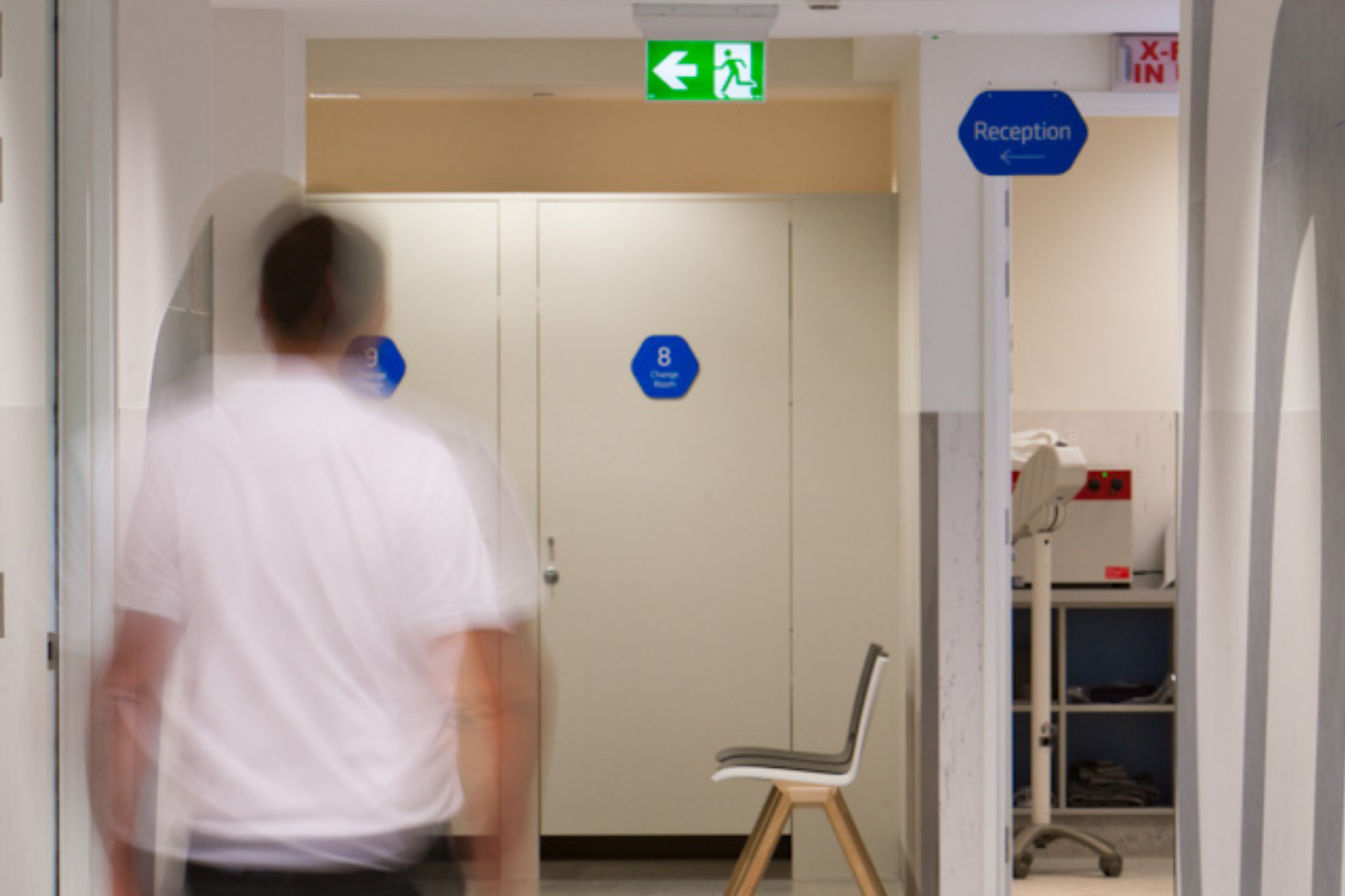 A Blurred Man In White Heading Towards The Exit | Ct Scan Clinic Near Me | Imaging At Olympic Park